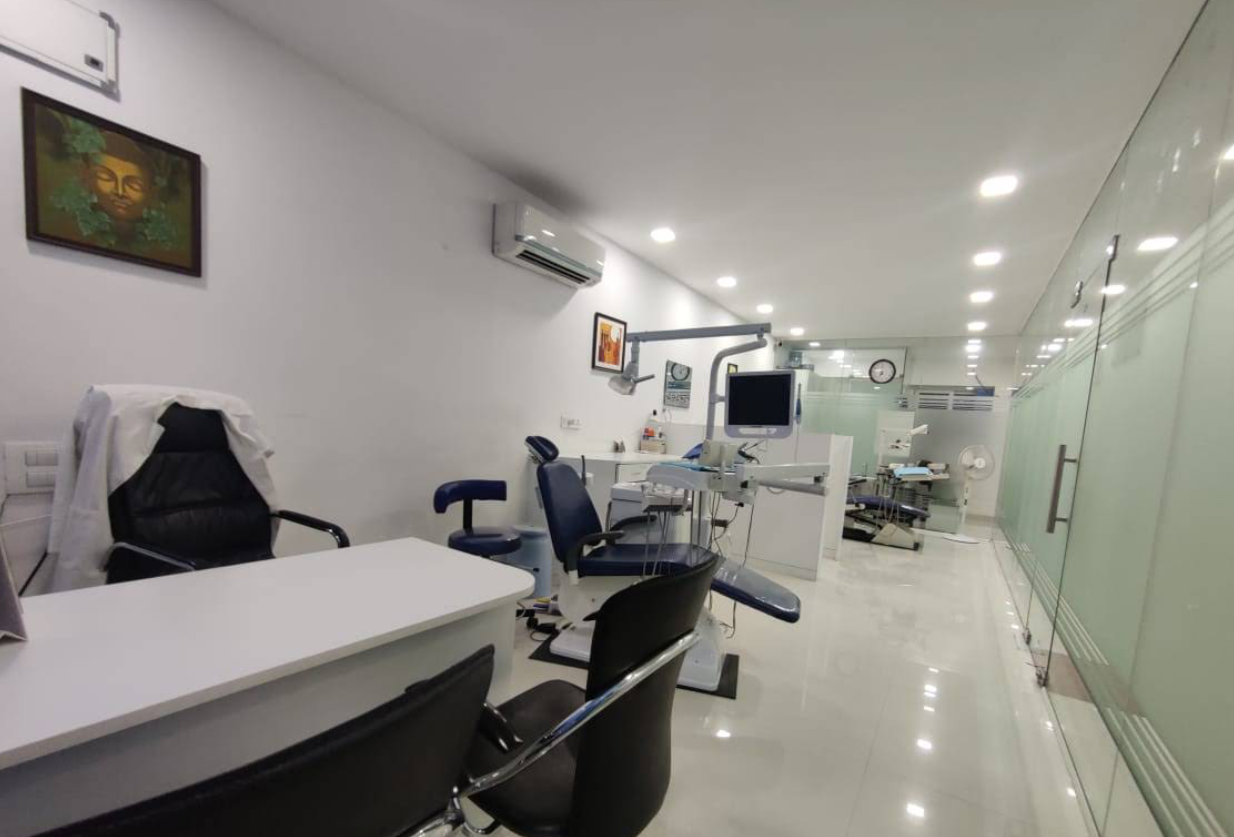 Inside Myperfect32 Dental Studio in Kondapur — treatment chairs, chairside monitor and a bright, glass-partitioned surgery